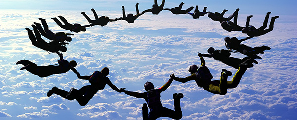 A group of people in the sky holding hands.